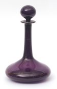 Bristol Amethyst glass decanter of shaft and bulb form with globular stopper, remaining traces of