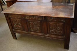 18th century oak coffer with three carved panel front on planked legs, 137cms wide x 61cms deep x