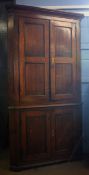Late 18th or early 19th century oak floor standing corner cupboard with four panelled cupboard