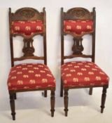 Set of four Arts & Crafts mahogany carved dining chairs with pierced splat backs with red elephant