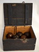 19th century pine box containing 8 lignum vitae bowls and a further old Bussey & Co Ltd of London