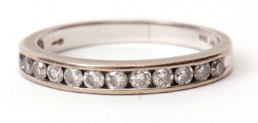 Modern precious metal and diamond half eternity ring, channel set with 12 small diamonds, stamped