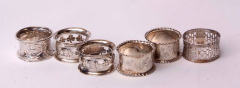 Mixed Lot: two Edward VII napkin rings of circular form with pierced shamrock detail and vacant