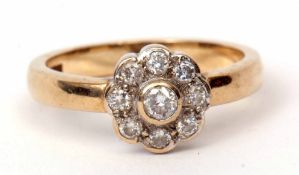 9ct gold diamond cluster ring, the principal central diamond bezel set and raised between an 8-