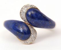Modern 9ct gold, lapis and diamond ring, a stylised design with two lapis serpent heads tipped by