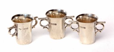 Three Edward VII two-handled spirit cups each of bucket form with cast and applied ring handles,