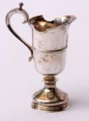 Elizabeth II small ewer of polished helmet form with applied rim and girdled body with applied C-