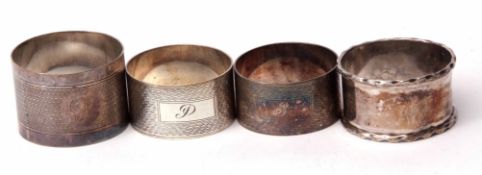 Mixed Lot: four various napkin rings including three cylindrical engine turned examples and a