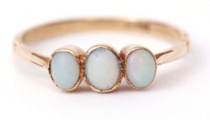 Three-stone opal ring, featuring three graduated cabochon opals in rub-over settings with pierced