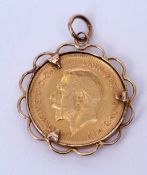 George V half sovereign, dated 1913 in a 9ct gold scroll frame mount
