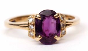 Modern 18K stamped amethyst and diamond ring, the oval shaped faceted amethyst claw set and raised