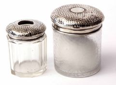 Mixed Lot: two various silver lidded and clear glass toiletry jars, each of cylindrical form with