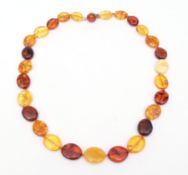 Modern large Baltic amber bead specimen necklace, the oval beads of mixed colours to a white metal