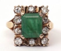 18ct gold emerald and diamond ring, the oblong shaped emerald 8 x 6mm, surrounded by 10 small
