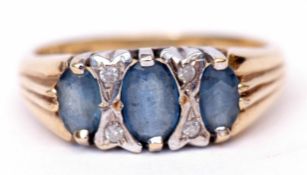Precious metal diamond and blue stone ring, the 3 graduated oval stones interspersed with 4 small
