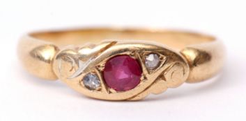 Yellow metal ruby and diamond ring, the central faceted ruby set between two small rose cut