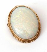 9ct gold and opal pendant brooch, the oval shaped cabochon opal framed in a hallmarked gold mount (