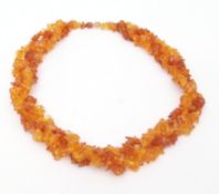 Modern amber fragment necklace, two strings intertwined and joined by a bead screw clasp