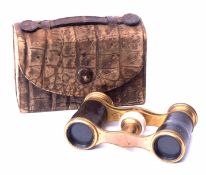 Cased pair of early 20th century gilt brass opera glasses with leather mounted bodies and mother
