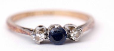 Sapphire and diamond three-stone ring, the circular cut sapphire flanked by two small diamonds,