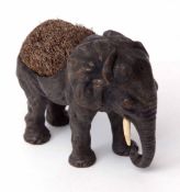 Late 19th century cold painted novelty pen wipe modelled in the form of a standing elephant with pen
