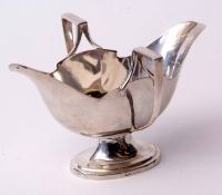 Edward VII double sided gravy boat of polished form with shaped rim and stylised handles on a