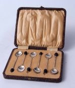 Cased set of six coffee spoons each with plain polished bowls, wire work handles and coffee bean
