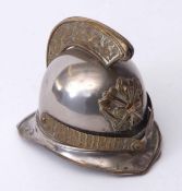 Late 19th century base metal table vesta case modelled in the form of a fireman's helmet with hinged