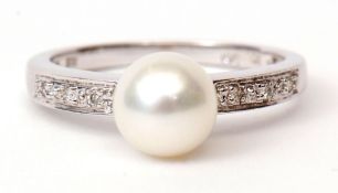 Modern precious metal diamond and pearl ring, the cultured pearl (6mm diam) raised between diamond