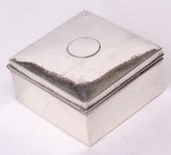 George V table cigarette box of hammered square construction with hinged cover set with a vacant