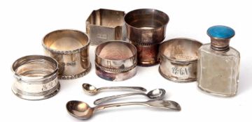 Mixed Lot: four various hallmarked silver napkin rings, together with a silver and enamel lidded