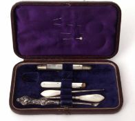 Cased part manicure set, the hinged and gilt highlighted morocco covered case with silk and velvet