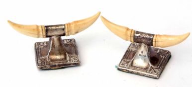 Pair of George V ivory mounted silver knife rests modelled in the form of buffalo horns and each