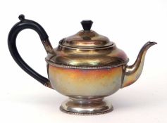 George V tea pot of circular form with hinged and domed cover on a spreading circular foot and