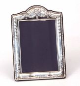 Elizabeth II silver mounted easel backed photograph frame of shaped rectangular form, the mount with