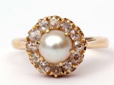 Antique pearl and diamond cluster ring featuring a single cultured pearl surrounded by 12 small