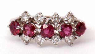 Ruby and diamond cluster ring, having a line of five circular cut rubies raised between two rows