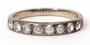 Precious metal diamond set half eternity ring featuring 8 small diamonds, claw set between part