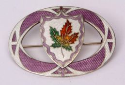 Vintage enamel large oval shaped brooch, applied to the centre with a shield cartouche, featuring