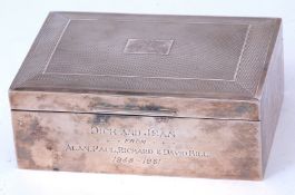 Elizabeth II cigarette box of hinged rectangular form with engine turned cover with central vacant