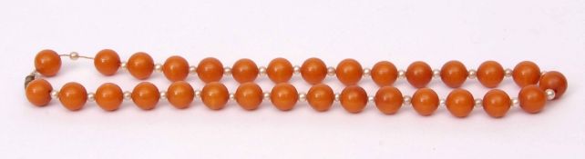 Vintage amber and seed pearl necklace, a single row of uniform beads (12mm diam), interspersed