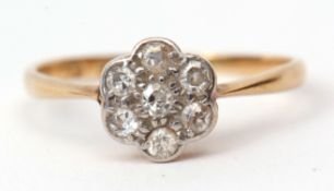 Precious metal diamond cluster ring, of flower head design, claw set with 7 small diamonds,