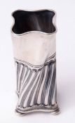 Victorian posy holder of wrythen square section and half fluted form, raised on four button feet,