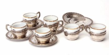 Six tea cups and saucers, the circular saucers with embossed rims and stamped "810, B" and further