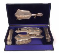 Cased Edward VII five-piece dressing table set comprising hand mirror, pair of hair brushes, pair of