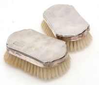 Two George VI silver backed hair brushes, each with shaped and engine turned backs with initialled