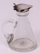George V silver mounted and clear glass whisky measure with star cut base and applied handle (top