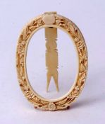 19th century carved ivory oval photograph frame with floral surround and easel back (incomplete),