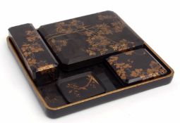 Collection of Japanese papier mache wares on a black tray including a large box and cover with a