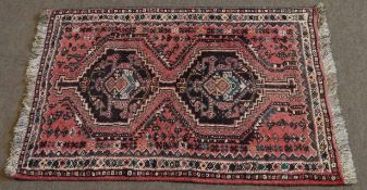 Small Caucasian style wool prayer rug, two lozenges to centre, mainly puce field, 80 x 123cms